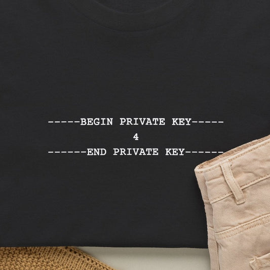 Close-up of the white monospace print on a black tee: -----BEGIN PRIVATE KEY-----, then 4, then -----END PRIVATE KEY-----